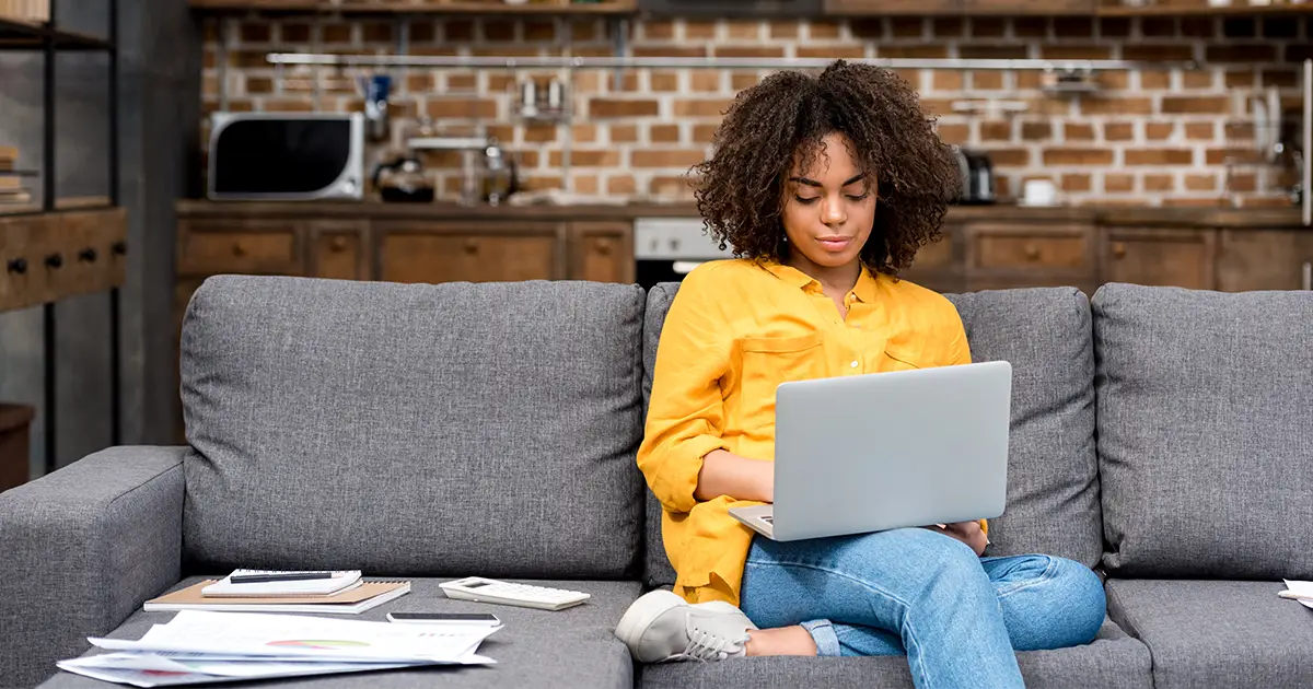 Woman working working with laptop on couch