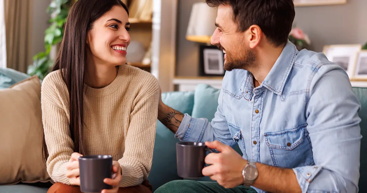 couple heureux buvant du café et se relaxant à la maison