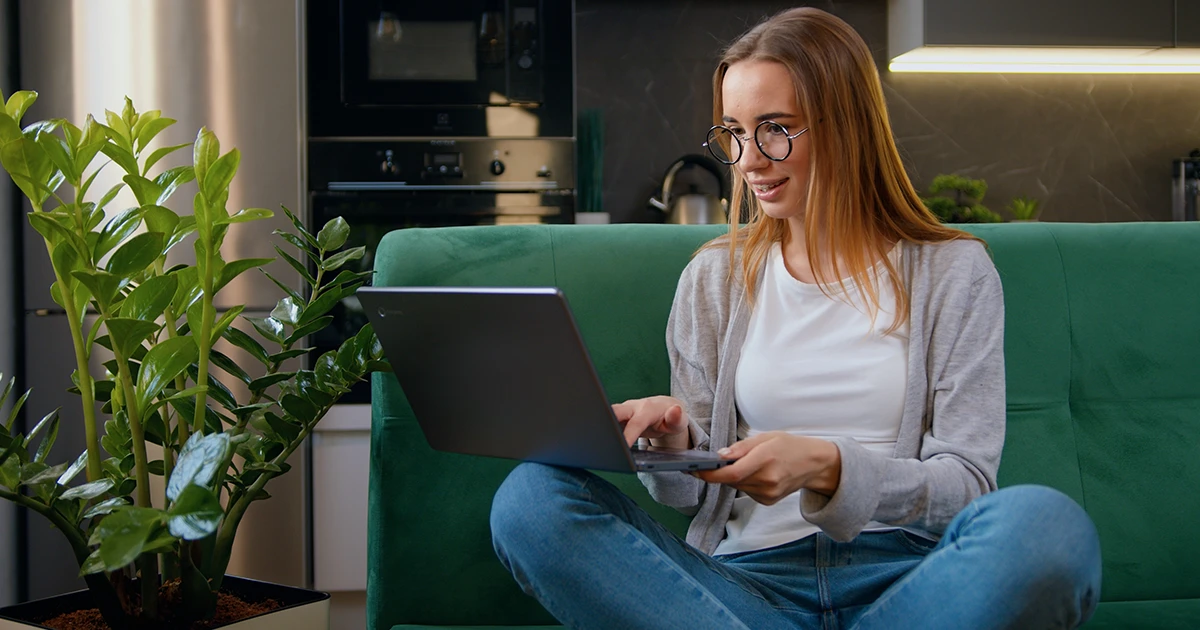 you woman working on a laptop in her living room